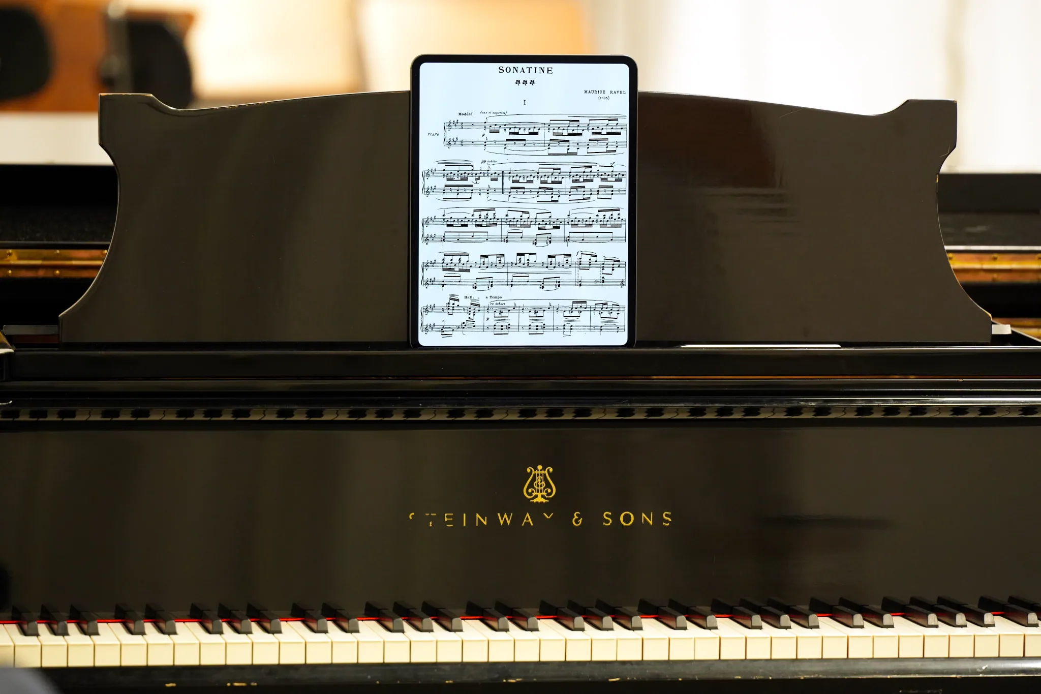 Piano sheet music on an iPad Pro, on a Steinway grand piano