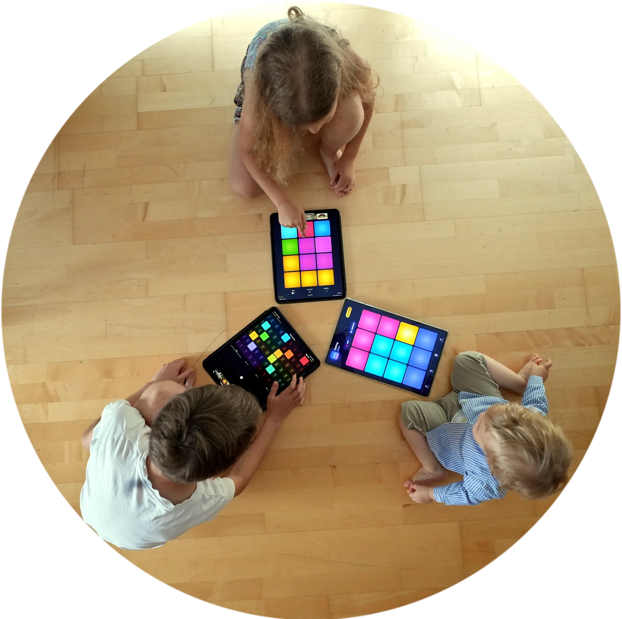 Children making music with Apple iPads and a Samsung Tablet