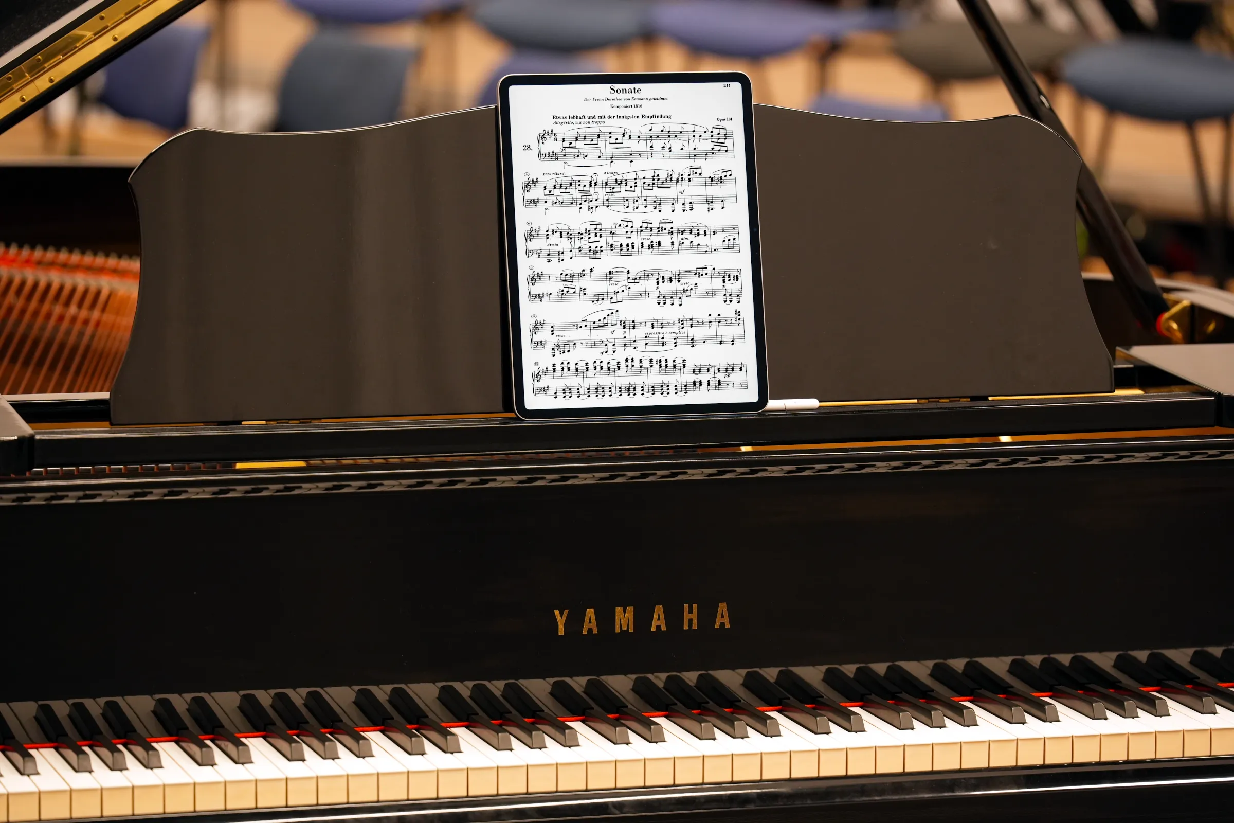 Sheet music on a large 13-inch iPad Air, on a Yamaha grand piano